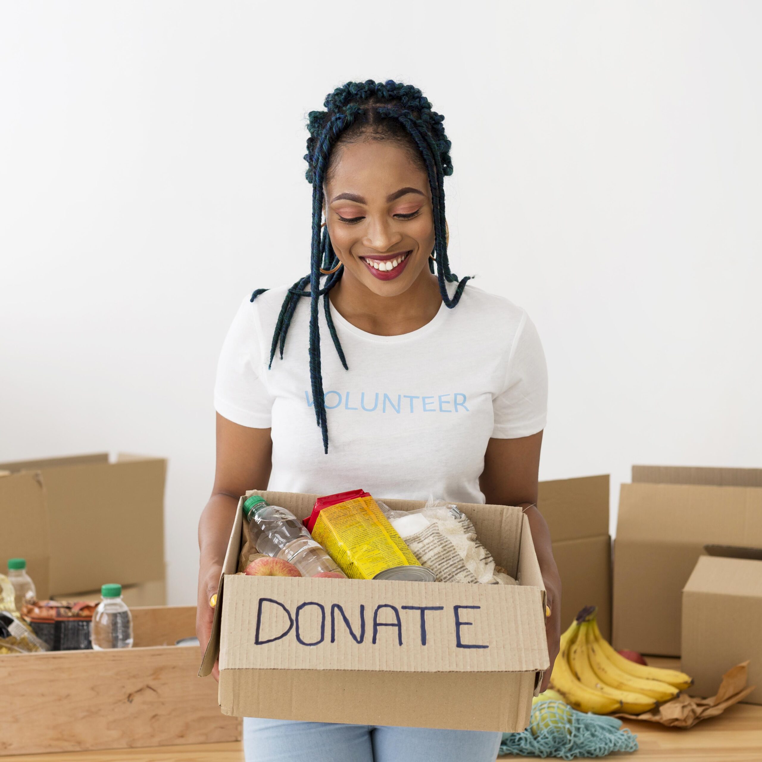 Smiley woman holding a box of donations